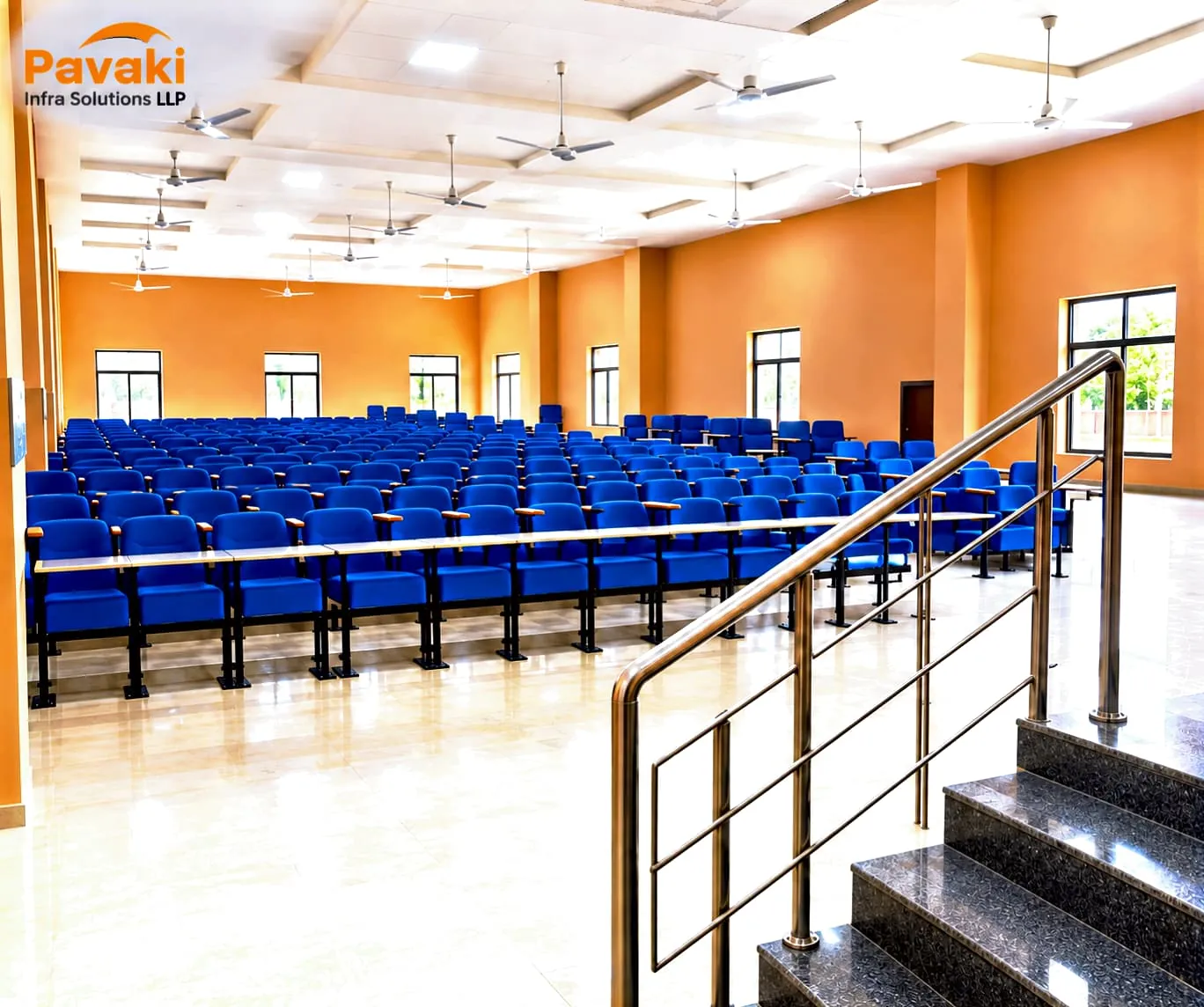 Auditorium hall with blue tiered seating at the Agra Sanskritik Sankul