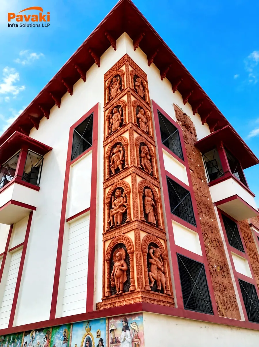 Restored white and red facade with carved terracotta panels, Tulsi Smarak Shodh Sansthan