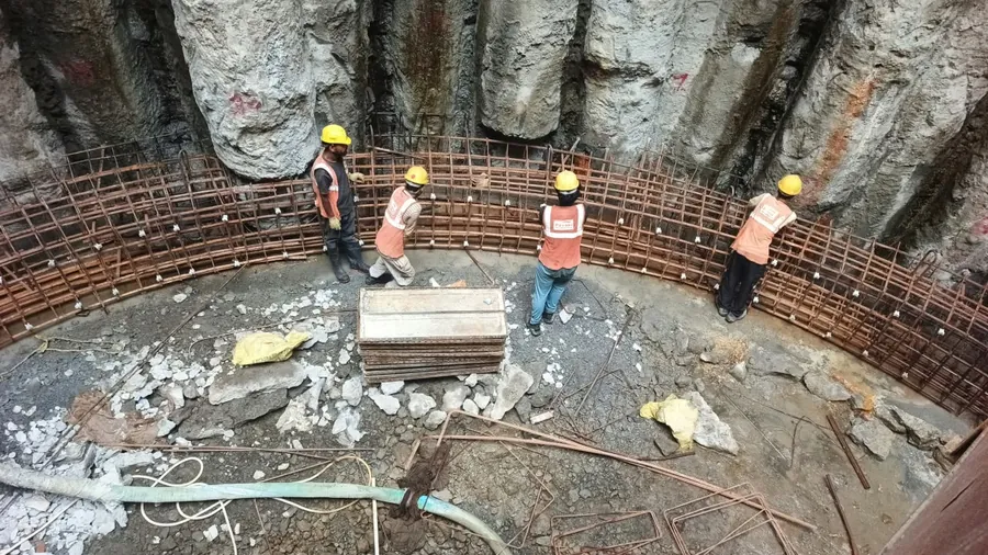 Crew fixing curved reinforcement for the shaft lining