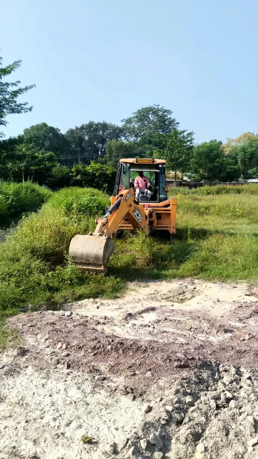 Backhoe clearing the hostel site at Sainik School, Lucknow