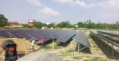 Solar installation in progress with workers and mounting structures